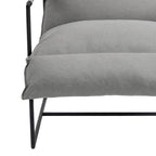 Fauteuil d'appoint en tissu, avec structure en métal et assise suspendue.